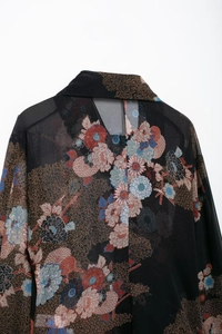 Close-up of the back of a vintage chiffon blouse with Japanese floral patterns