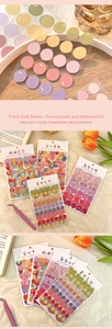 Close-up of waterproof PET floral bubble stickers on wooden desk for DIY scrapbooking