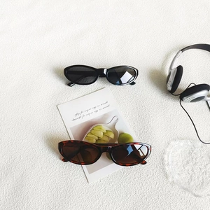 Retro oval sunglasses in black and tortoiseshell frames with UV protection lenses
