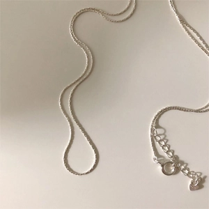 Detail of 925 sterling silver chain necklace with lobster clasp and heart pendant