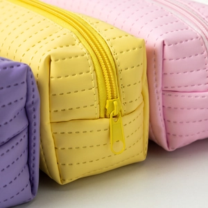 Close-up of pastel pencil cases with textured PU leather and matching resin zippers