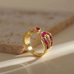 Double-layered gold-plated snake ring with red stones and crisscross open design