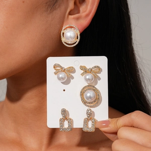 12-piece vintage geometric earring set with pearls and diamonds on a display card