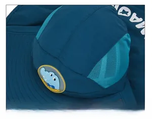 Close-up of flat stitching and breathable mesh on a navy blue sun hat for kids