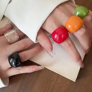 Detailed view of colorful geometric acrylic rings in red orange and green finishes