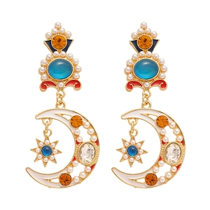 Vintage gold moon and star earrings with faux pearls and colorful gemstones on white background
