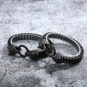 Detail of Viking wolf head bracelets in silver and black stainless steel finish