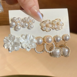 Detail of 5-piece earring set featuring pearl flowers and sparkling cubic zirconia studs