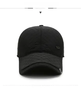 Detailed front view of black quilted winter baseball cap with ear flaps and metal badge