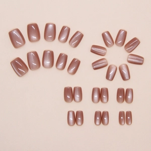 Detailed view of cat-eye rose gold press-on nails with shimmering finish in short square shape