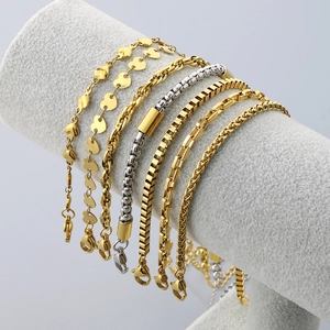 Close-up of assorted gold and silver heart-shaped adjustable stainless steel anklets