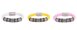 Détail de bracelets en cuir tressé avec fermoirs magnétiques et perles en métal gravées