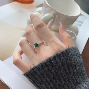 Detailed macro view of S925 sterling silver ring with emerald cut green zircon stone