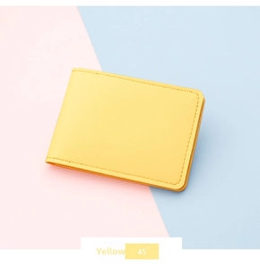 Detail of yellow ultra-slim PU leather card holder with precise edge stitching