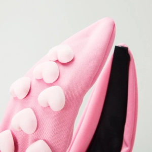 Pink knotted headband with heart-shaped embellishments and soft plush knit texture
