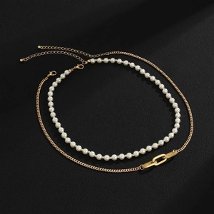 Detailed view of a double-layered set featuring a white pearl strand and golden metal chain