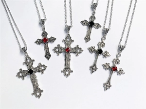 Detailed view of assorted gothic cross necklaces with red and black crystal accents