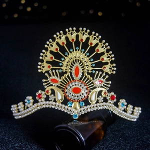 Luxurious gold crown with red and blue gemstones and pearls for wedding hair accessory