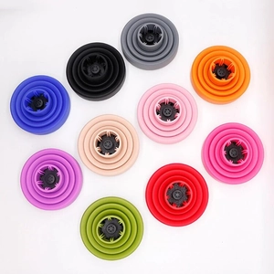 Collapsible silicone hair dryer diffusers in ten vibrant colors on a white background