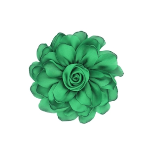 Detail of multi-layered green satin rose flower with delicate ruffled petal texture