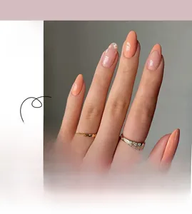 Detail of French style press-on nails featuring soft pink borders and white floral patterns