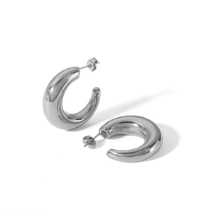Detailed view of silver minimalist C-shaped hoop earrings with polished metallic luster