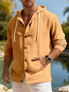 Detail of mustard yellow linen shirt featuring drawstring hood and resin button texture