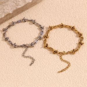 Detail of gold and silver coffee bean knot link anklets with adjustable lobster clasp