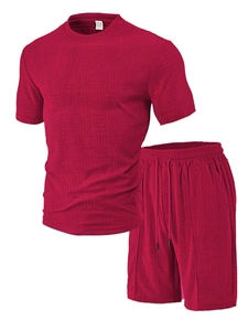 Detail view of red knitted texture polo shirt and drawstring shorts on white background