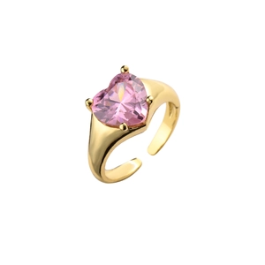 Adjustable golden ring with a heart-shaped pink zircon stone on a white background