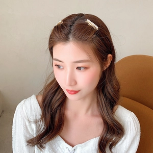 Elegant gold pearl hair comb set for women featuring polished white pearls on a side profile
