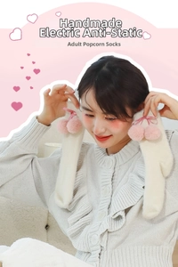 Detail of white knit socks with pink plush pom-poms and ribbon bows in Japanese style