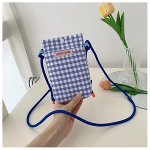 Detail of a blue and white checkered fabric phone bag with a pink HDBFORM brand label
