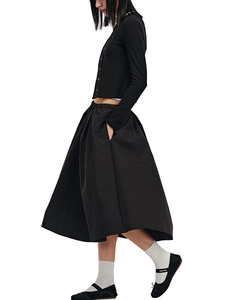 Side view of a minimalist black long-sleeve cardigan and flared midi skirt set