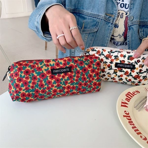 Retro corduroy makeup pouch with floral patterns and a side handle for easy carrying