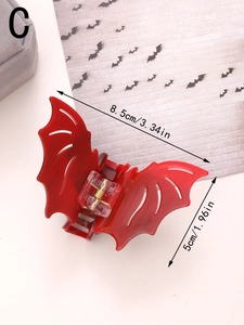 Detailed view of dark red bat hair claw with 8.5cm x 5cm dimensions for Halloween styling