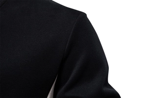 Close-up of shoulder stitching and fine knit texture on a men's black sweatshirt