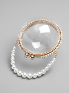 Elegant transparent spherical evening bag with gold metal frame and white pearl handle