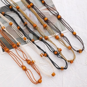 Detail of bohemian hand-woven waist chains with wooden beads in five varied colors