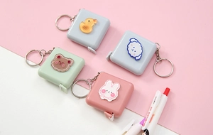Close-up of portable square retractable tape measures with cute cartoon animal designs