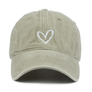Detailed close-up of embroidered heart on vintage washed cotton baseball cap texture