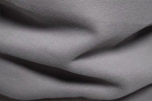Macro shot of grey cotton blend fabric texture showing soft knit fibers and fine weaving
