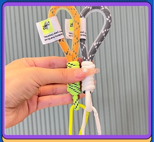 Close-up of woven mesh wristlet keychains with metallic carabiners and tag detail