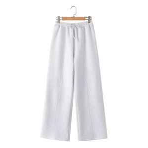 Detail of light grey wide-leg joggers with drawstring elastic waist and center pleat