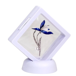 Blue enamel flower brooch with rhinestones and pearl in a white display box