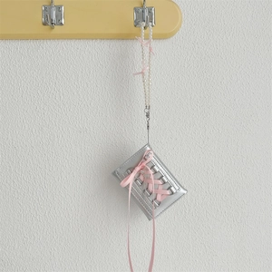 Silver PU wallet with pink ribbon cross straps and pearl chain accessory detail