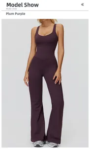 Detail showing cross back and flare leg design of plum purple yoga jumpsuit for sports