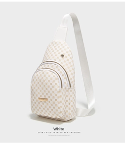 Detail of white sling bag showing double zip compartments and golden circle patterns