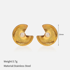 Detail view of 23mm fan-shaped 18k gold plated earrings with white pearl inlay