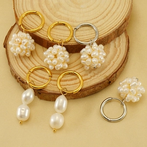 18k gold plated stainless steel hoop earrings with natural pearls on a wooden base